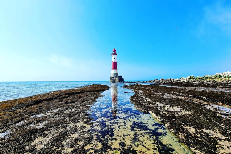 Beachy Head lighthouse at low tide, by Fiona Coutts. SUS-210505-102012001