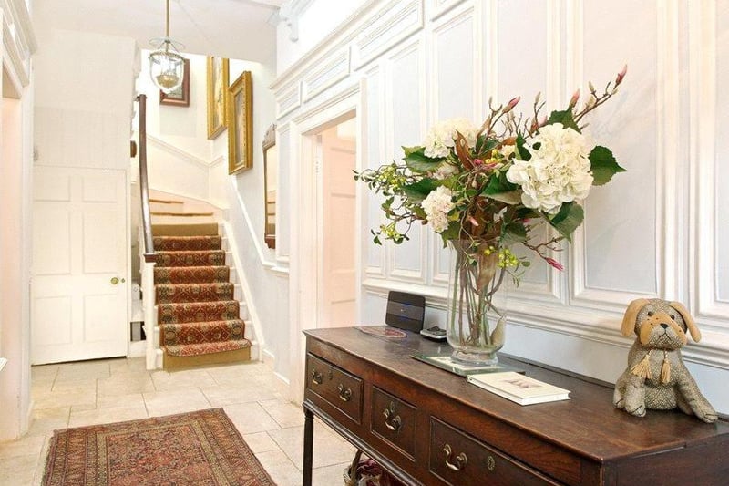 The main reception rooms radiate off the hallway and a wooden staircase with a polished handrail proceeds to the first-floor galleried landing.