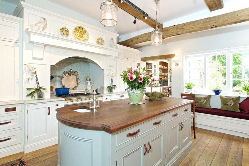 The kitchen has been lovingly restored with timeless bespoke classically designed fitted cabinetry with attention to detail.There are Oak ceiling beams, and Oak flooring continues through an opening into the second kitchen.