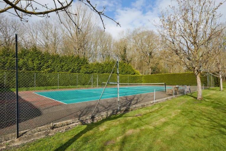 The property even comes with a tennis court