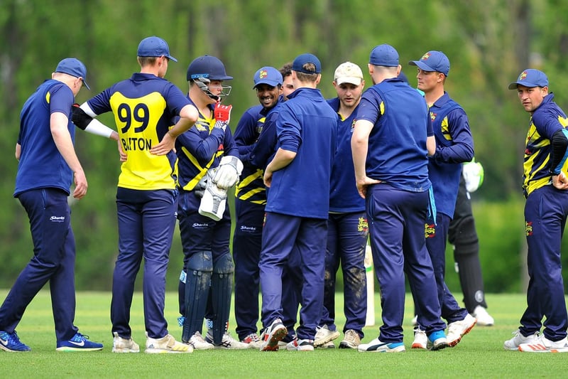 Hastings gather after a wicket