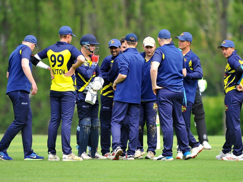 Hastings gather after a wicket