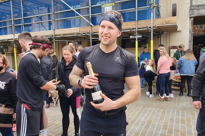 Liam celebrates with champagne at the finishing point.