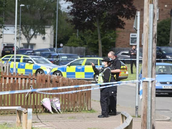 Police at the scene following last night's fatal stabbing of a 16-year-old boy in Corby