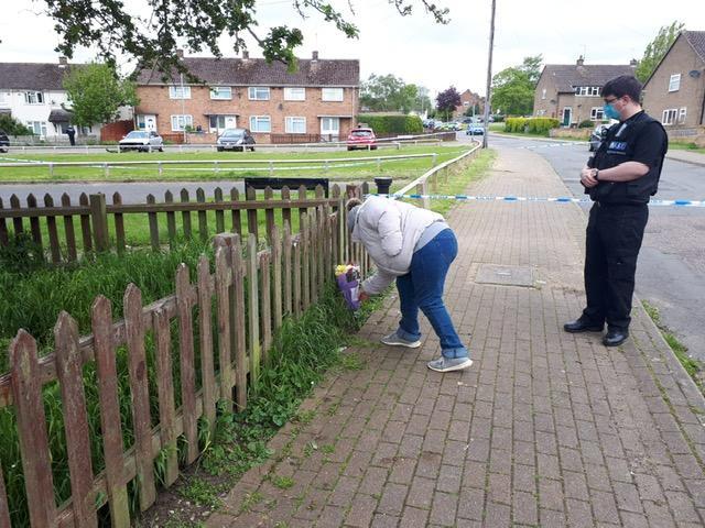 A resident laying flowers at the scene