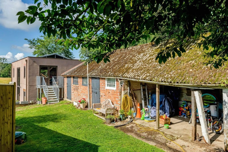 The garden is mainly laid to lawn, surrounded by mature hedgerows and trees, with a small kitchen garden and fruit trees. Picture: Savills Haywards Heath.