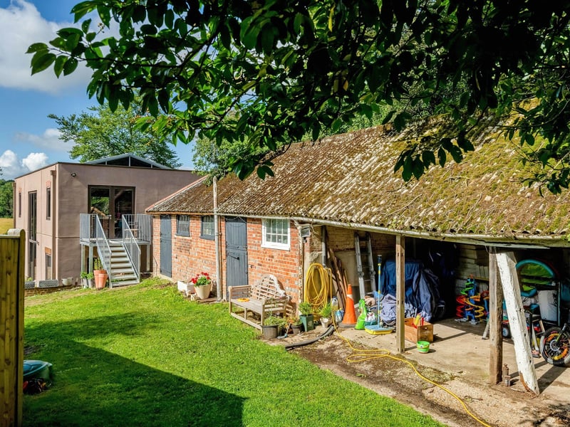 The garden is mainly laid to lawn, surrounded by mature hedgerows and trees, with a small kitchen garden and fruit trees. Picture: Savills Haywards Heath.