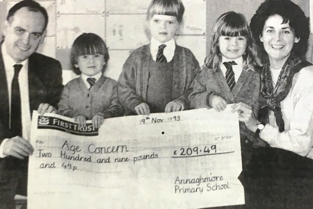 Pupils from Annaghmore Primary School presented a cheque to Age Concern in 1993. Leo Swift from the charity received the cheque from Margaret Forde, Jennifer Maybury and Claire Johnston. Also pictured is principal Florence Anderson