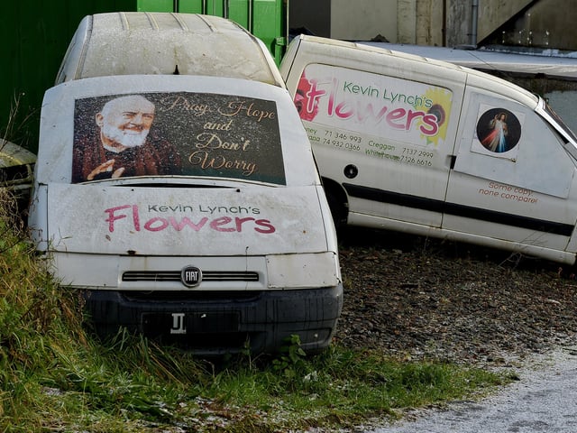 Windscreen of van protected by Padre Pio sign. DER2102GS - 023