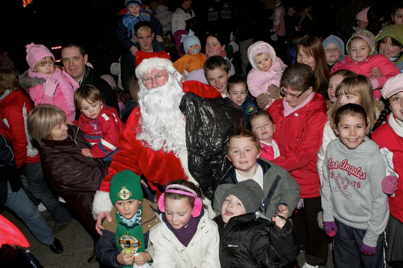 Santa gives presents to the children of Scotch Street during the lights switch on in 2008