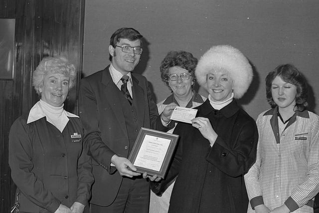 Anthony Herron, British Home Stores Belfast manager, hands over a cheque for £104 to Liz Dennes, education officer with the Ulster Cancer Foundation, in January 1981. Mrs Kathleen Thomas, Mrs Jean Rea, and Sandra Barclay from the staff consultancy committee are also included in the photograph. Picture: News Letter archives
