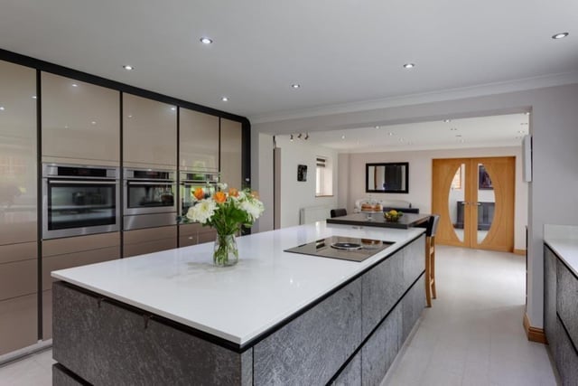 The heart of the home is this magnificent and spacious bespoke modern kitchen which has an induction hob and integrated extractor set into the central island, the quartz work surface extending to provide seating for three people. There are two combination ovens, a microwave, under-counter fridge and an integrated dishwasher.
