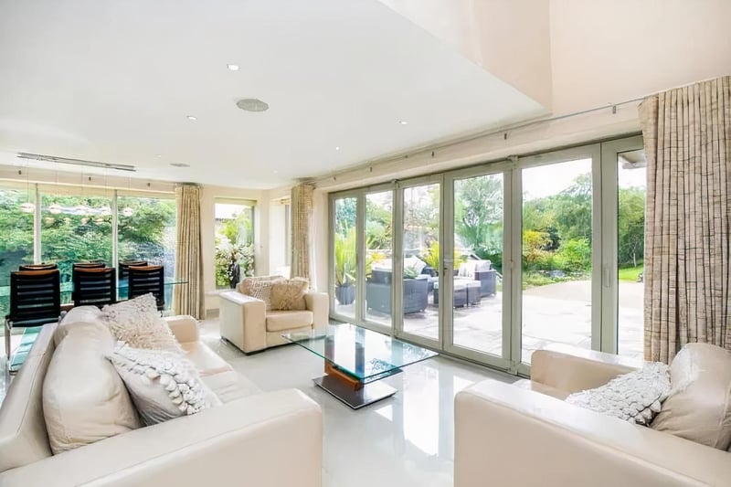 The living area offers space to relax with bi-fold doors which open to a south facing terrace.