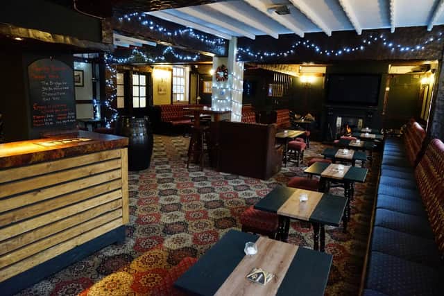 The Bridge Inn's bar and tables have been given a new look as part of the pub's redecoration. The open fire remains and offers a warm welcome to customers old and new.