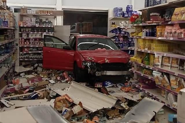 The car was driven through the store window, causing substantial damage.