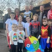 Children dressed as superheroes to remember their late head teacher