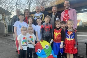 Children dressed as superheroes to remember their late head teacher
