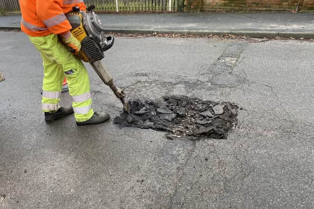 Pictured is a Derbyshire County Council worker repairing one of the many potholes on the county's roads, courtesy Of Derbyshire County Council