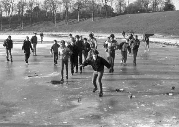 Children sliding on a frozen Inverleith pond, iced over during the cold weather in February 1985.