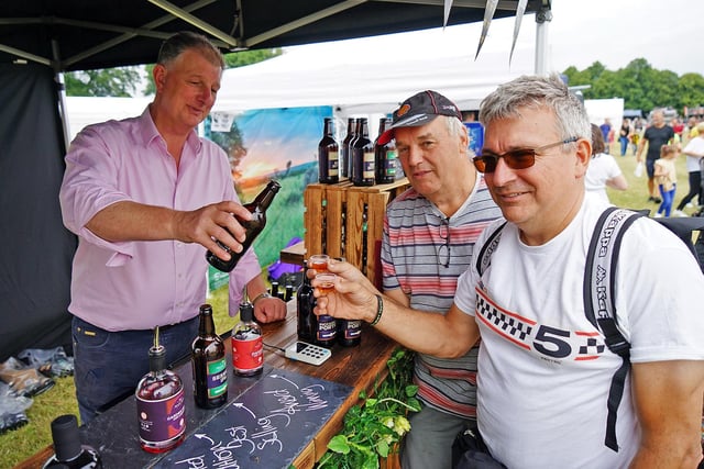 The Great British food festival returns to Hardwick Hall. Simon Cokerill from Isaac Poad Brewing giving samples to Dave Tilly and Bernard Simpson.