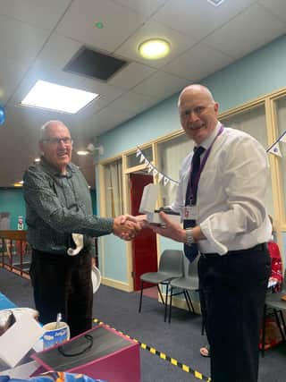 Neil Malenoir (pictured right) being congratulated by Adrian Evans, chairman of the board at Belper Leisure Centre, on his retirement