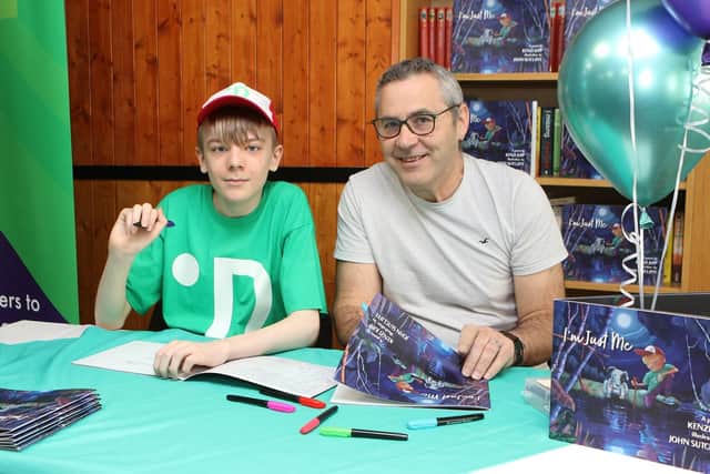 Kenzi Jupp and the illustrator of his book John Sutcliffe signing copies at Tupton Village Hall