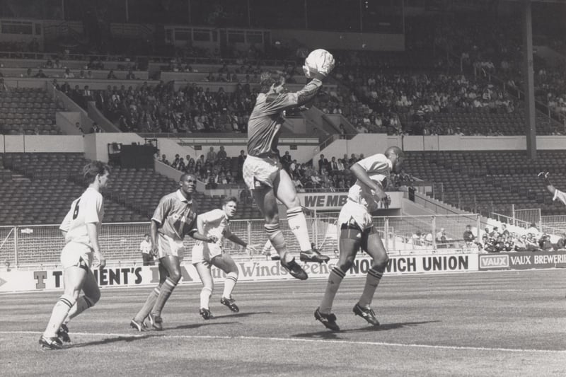 Cambridge goalkeeper John Vaughan leaps high to save from a Chesterfield attack. Chesterfield were beaten 1-0.