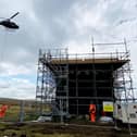 A helicopter airlifts in materials to the Cowburn Tunnel repair project