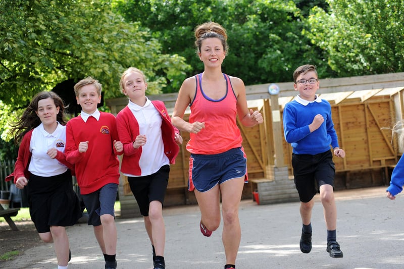 Amy Hughes, who has run 53 marathons, is pictured with pupils from the Richardson Endowed Primary School.