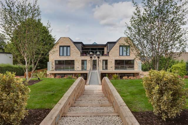 A gravelled path leads to the landscaped communal gardens; timber steps with gravel insets also lead down to the apartment's private seating terrace.