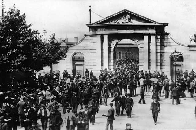 Workers leaving for the day at Portsmouth Dockyard's Unicorn Gate about 1910.
Picture: costen.co.uk