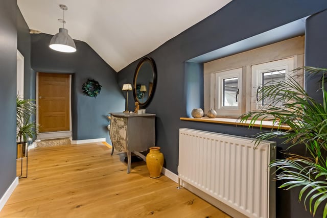 There is a half-landing on the climb upstairs from the kitchen, off which is a bedroom. A main landing gives access to two bedrooms and a bathroom. A galleried walkway overlooks the dining room.