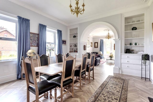 The  dining room has two large built-in display cupboards and drawers for storing crockery and tableware.  An open archway leads into a grand living room with beautiful plaster coving to the ceiling  and a bay window.