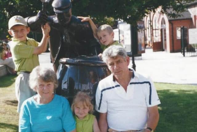 Pauline and Ron Holden with three grandchildren