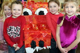 Charlotte Oxley, Connor Gregory, Caitlin South and Gemma Barthorpe with a Chinese dragon at Whitecotes School, Chesterfield.