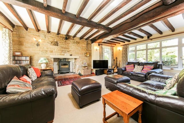 Plenty of space for family and guests to spread out in this good-sized lounge where a log burner keeps residents warm on cold nights and sunshine lights up the room during the day.