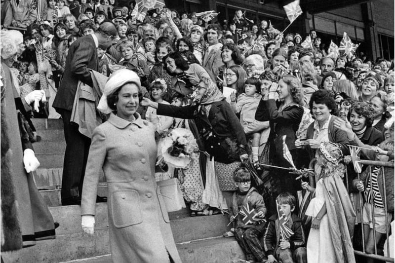 Cheering crowds greet the Royal couple at Doncaster Racecourse in 1977.