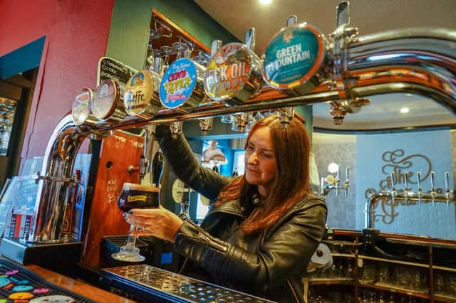 Sally pouring a pint of Kasteel at the Neppy