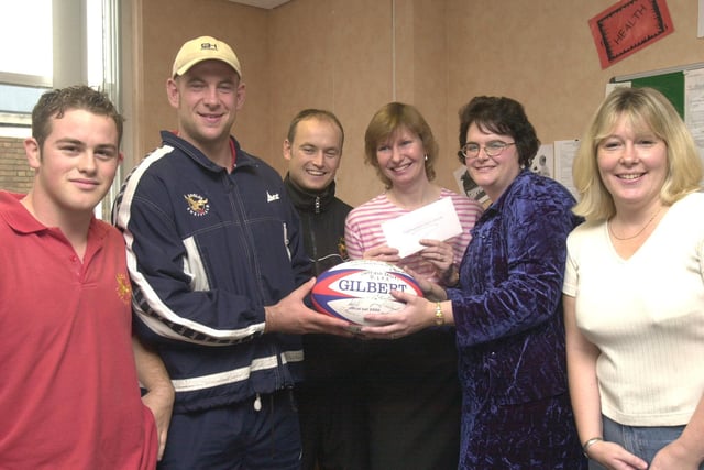 Eagles captain Richard Goddard presented prizes in a charity draw in aid of  Juvenile Diabetic Research held at the National Westminster Bank, High Street in 2001,  Receiving the autographed ball is  Gillian Barnfield. Looking on are from left,  Lee Bettinson and Gavin Brown both from the Eagles, Jean James who received  tickets and Anne Valetine, right, the organiser.