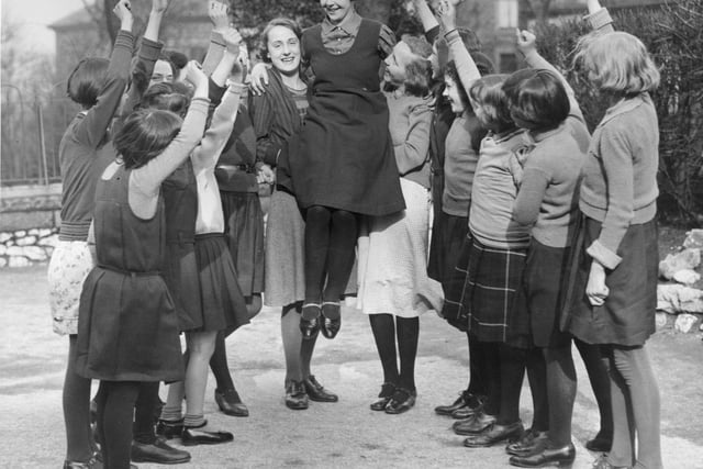 14 year old Buxton schoolgirl Peggy Mycock is cheered by her friends for being chosen as the 1934 Festival Queen of Buxton. She was selected out of 30 girls from local elementary schools.  (Photo by Fox Photos/Getty Images)