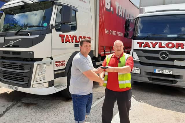 Kyle Thorburn receives his wallet from Bill Shaw - B Taylor & Sons Transport