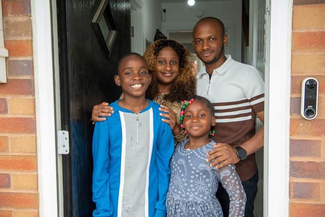 Adeola and Olufemi with their children Bolu and Bukunmi in the doorway of their new Bellway home.
