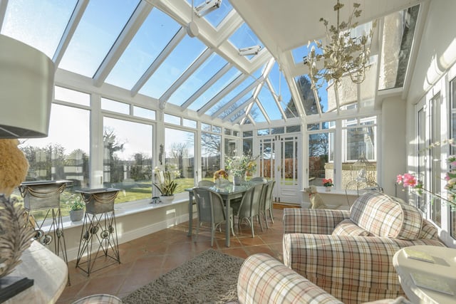 The conservatory adjoining the south elevation of the property is the perfect space for relaxing in the summer months.