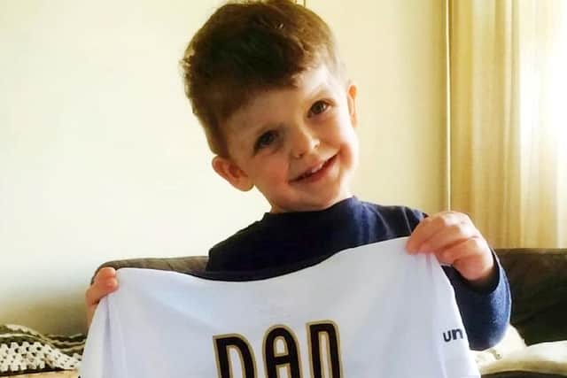 Daniel on his third birthday receiving a Derby County Football t-shirt.