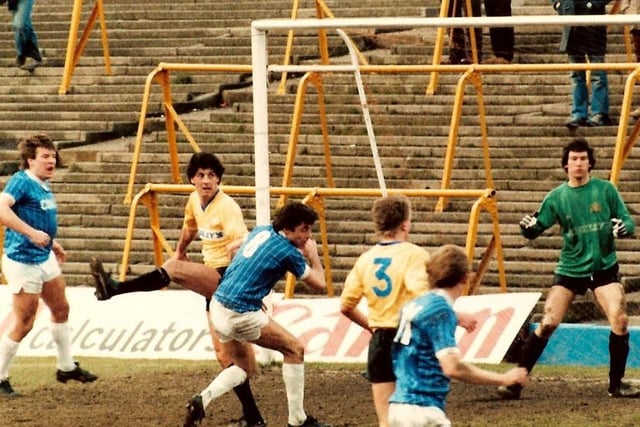 A Chesterfield attack on the Halifax goal from the game on March 16th, 1985, which Chesterfield won 3-0. Ernie Moss takes evasive action as defender Steve Brookes heads clear.