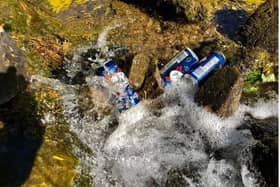 Beer cans dumped in a river in the Peak District.