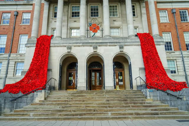 Chesterfield Town Hall is decorated with a cascade of thousands of woollen poppies knitted and crocheted by local residents.
The Poppy cascade was installed on the front of the Town Hall on Thursday 3 November by members of The Royal Engineers Association, who are the custodians of the Poppies. Each year the Royal Engineers Association ensure the Poppy fall’s safekeeping, making sure it is dry and safely stored and any repairs are carried out prior to their next outing.
