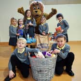 Pupils at Watchorn Christian School in Alfreton are collecting for their local foodbank. Seen are youngsters from star and rockets class with school lion mascot Judah.