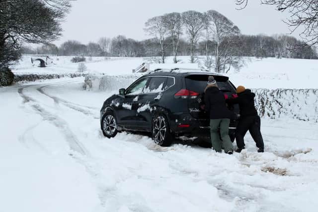 A Nissan X-Trail gets a helping hand after getting in the Derbyshire Peak District near Biggin earlier this winter. Image: Rod Kirkpatrick/F Stop Press.