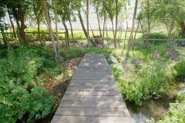 The woodland area features the bridge which goes over the Golden Brook.